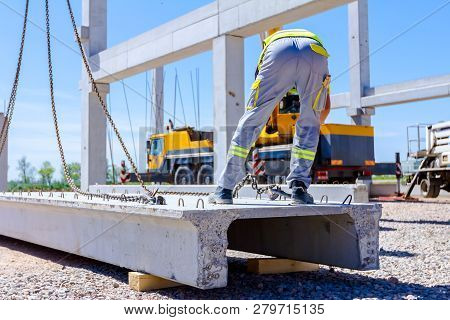 Rigger Is Fastening Crane Hooks To The Concrete Joist For Lifting To Assembly Structure.