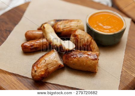 Grill-fried sausages with Romesco sauce on restaurant table