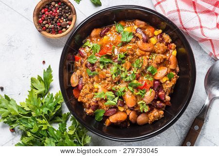 Chili Con Carne From Meat, Beans And Vegetables In Black Plate On Stone Table. Traditional Mexican F