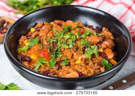 Chili Con Carne From Meat, Beans And Vegetables In Black Plate On Stone Table. Traditional Mexican F