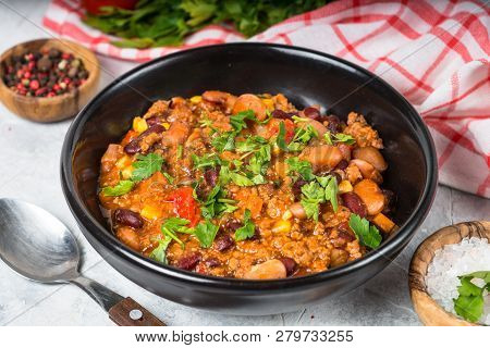 Chili Con Carne From Meat, Beans And Vegetables In Black Plate On Stone Table. Traditional Mexican F
