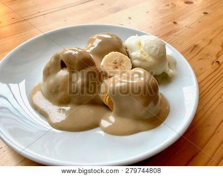 Profiteroles With Tahin / Tahini Sauce And Banana Slice Served At Restaurant.