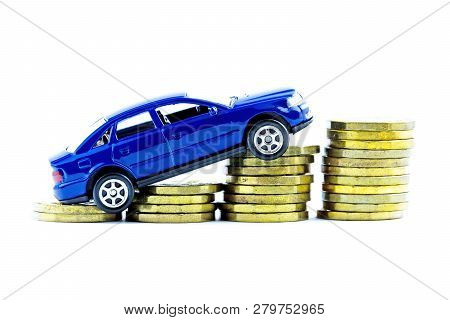 Model Of Blue Car And Coins On A White Background