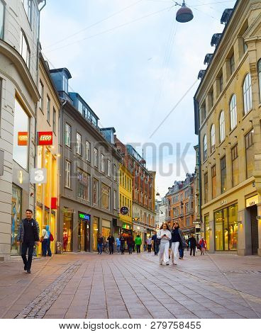 Copenhagen, Denmark - June 16, 2018: People Walk By The Stroget Street - The Main Shopping Street Of