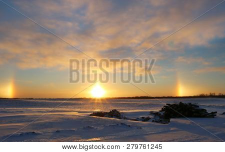 Magnificent Sunrise With Cloudy Sky On A Very Cold January Winter Morning With Two Sundogs