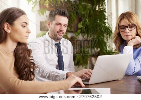 Group Of Business People Using Laptop While Working In The Office
