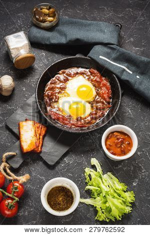 Shakshuka, Fried Eggs In Tomato Sauce In Iron Frying Pan. Typical Israel Food