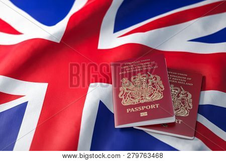 UK passport on the flag of the United Kingdom. Getting a UK passport,  naturalization and immigration concept. 3d illustration