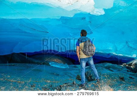 Man In Blue Ice Cave Of Svartisen Glacier In Norway
