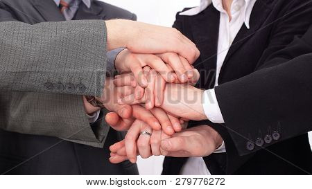 Group Of Business People With Hands Clasped Together.