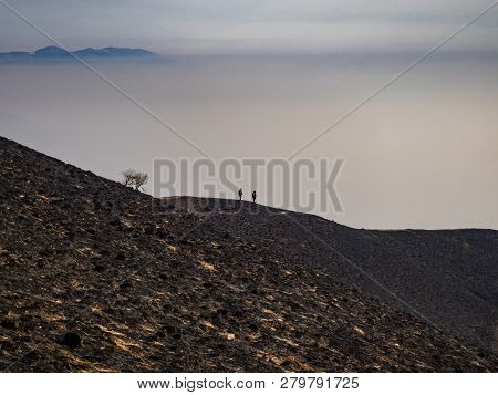 Hikers On Burnt Slopes Of  Monte Bollettone, Lombardy, Italy