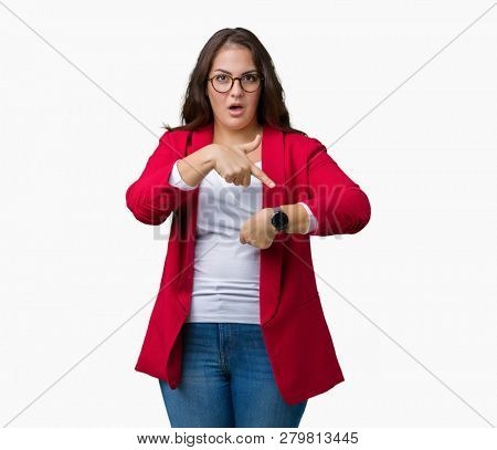 Beautiful plus size young business woman wearing elegant jacket and glasses over isolated background In hurry pointing to watch time, impatience, upset and angry for deadline delay
