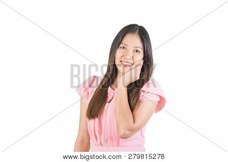Smiling Attractive Asian Young Woman In Pink Dress Using Hand Touch The Cheek With Clipping Path.
