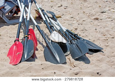 Boat Oars Lie On The Sand On The Beach By The Sea