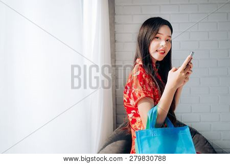 Smile Of Portrait Beauty Asian Woman With Chinese Dress,qipao,cheongsam Chinese New Year Using Smart