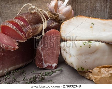 Group Of Smoked Ham, Jerky, Salted Biltong Meat, Lard With Some Garlic And Herbs
