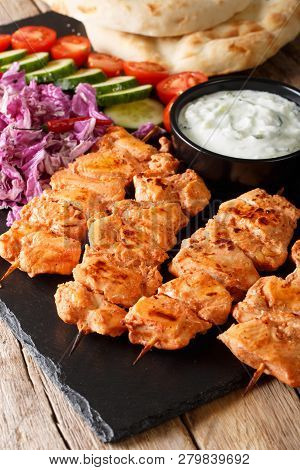 Lebanese Taouk Chicken Skewers Served With Fresh Vegetables, Sauce And Pita Close-up. Vertical