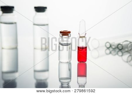 Group Of Vials With Medication On Blue Methacrylate Table. Horizontal Composition.