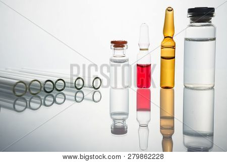Group Of Vials With Medication On Blue Methacrylate Table. Horizontal Composition.
