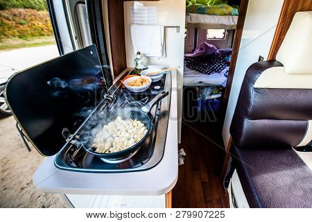 Cooking Dinner Or Lunch In Campervan, Motorhome Or Rv. Preparing Chicken  In A Pan In Camper Van Whe
