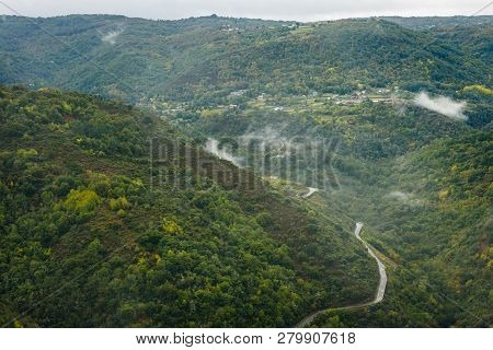 View Of Asphalt Road, Forest And Vineyards Along River Sil.