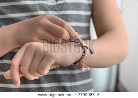 Horizontal Toned Shot Of A Female Hand Wearing Braided Bracelets