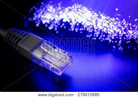 Glowing Fiber Optic Cable And Connector Rj-45 On A Dark Background. Modern Communications Abstract H