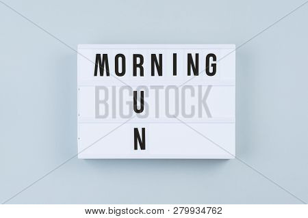 Motivation Text On Cinematic Light Box Morning Run On Gray Background, Flat Lay, Top View. Minimal H