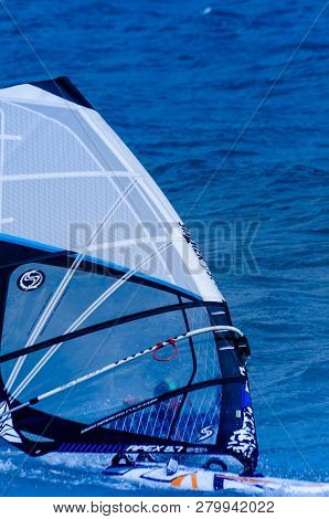 Malaga, Spain - May 25, 2018 Windsurfer Practicing Active Water Sport In The Bay Of Malaga, A Place