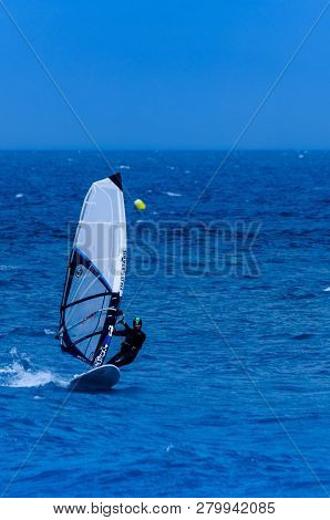 Malaga, Spain - May 25, 2018 Windsurfer Practicing Active Water Sport In The Bay Of Malaga, A Place