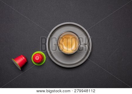 Espresso Coffee Cup And Capsules, Pods, On Black Color Background