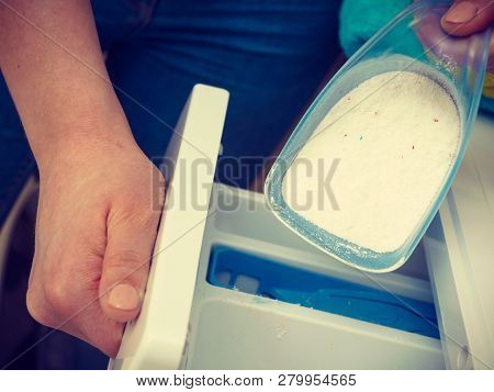 Washing Powder Detergent And Measuring Cup Pouring Into Machine. Household Duties, Clothes Laundry O
