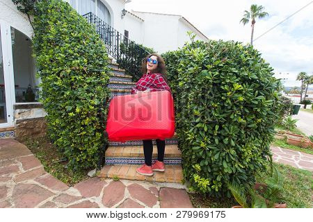 Travel, Tourism And Journey Concept - Happy Young Woman Climbing Up The Stairs With Red Suitcase And