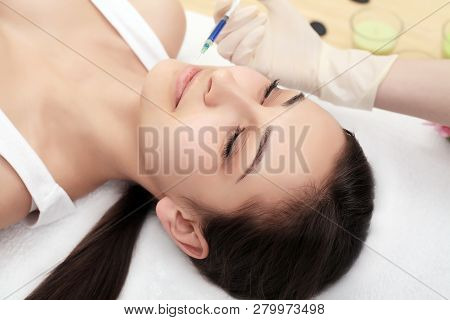 Woman Gets Injection In Her Face. Beauty Woman Giving Injections. Young Woman Gets Beauty Facial Inj