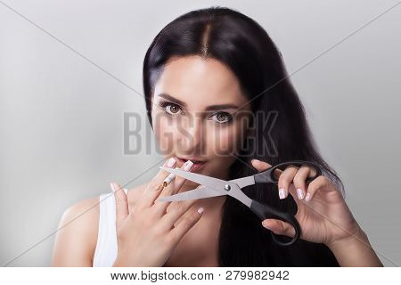 No Smoking. The Girl Cuts The Cigarette With Scissors. Against Smoking The Concept Of Health. On A G