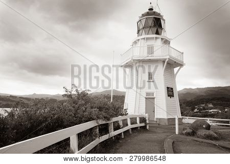 Akaroa New Zealand - October 13 2018; Vintage Sepia Toned Image Lighthouse At Akaroa Head On Cloudy 