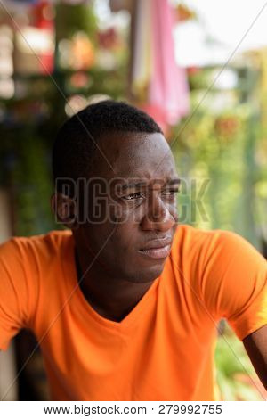 Face Of Young Black African Man Thinking While Looking At Distan