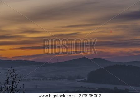 Sunrise On Boren Hill Near Bilina Town In Winter Frosty Color Morning