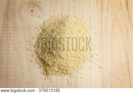 Pile Of Raw Round Rice On Light Wooden Board