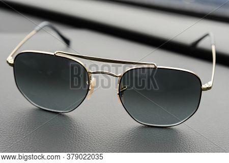 Fashionable Sunglasses. Sunglasses With Mirrored Lenses On Leather Table. Mirrored Sunglasses With A