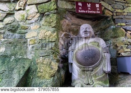 Busan, South Korea - July 20, 2017 : Ancient Buddha Of Granting A Son Stone Sculptures In Chinese Cu