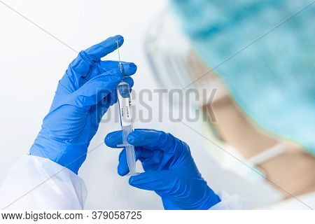 Doctor, Scientist, Researcher Hand In Blue Gloves Or Protective Suit Preparing For Human Clinical In