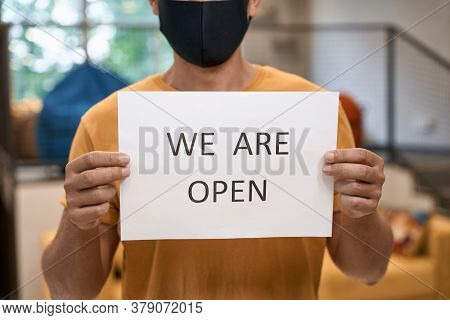 Business After Lockdown. Close Up Shot Of A Male Office Worker In Black Protective Mask Showing Pape