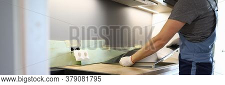 Repairman Installs Hob Kitchen Table In Apartment. Installation Hob In Countertop. Purchase New Kitc