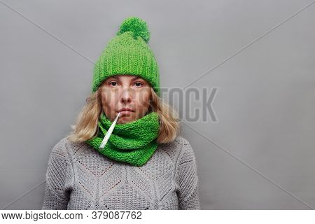Woman Looks Sick And Has A Fever Thermometer In Her Mouth