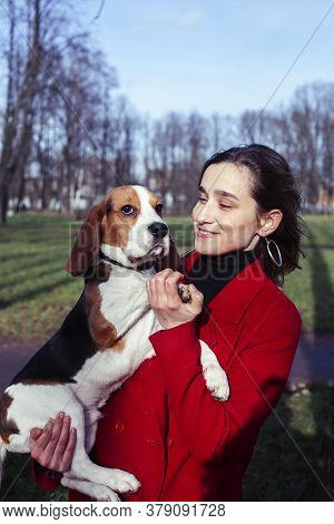 Pretty Young Girl In Redd Coat Playing With Dog Outside In Green Park, Lifestyle People Concept