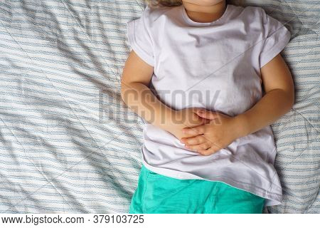 Abdominal Pain In A Preschool Child. Poisoning In Children. The Boy Holds His Hands To The Abdominal