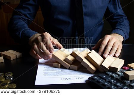 A Businessman Destroyed A Wooden Tower By Taking Out The Bottom Block Of The Foundation.management O