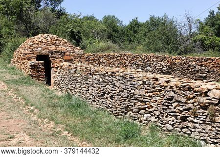 Old And Typical Stone Hut Called Caborne In French Language In Saint Cyr Au Mont Dor, France