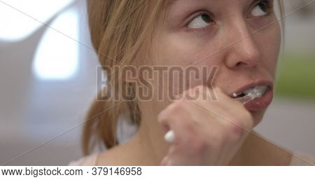 Beautiful woman brushing her teeth. In bathroom. The slowmotion.